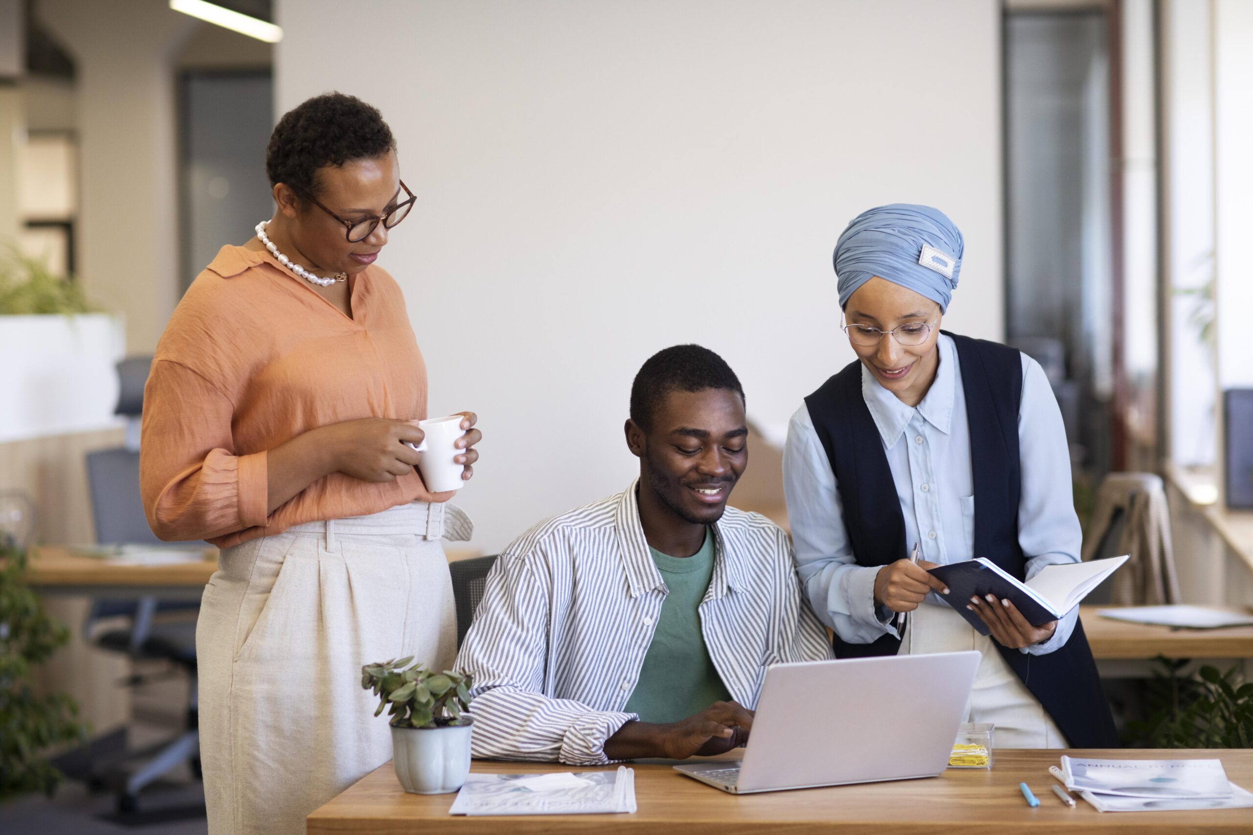 male-employee-getting-used-his-new-office-job-along-with-female-colleagues (1)